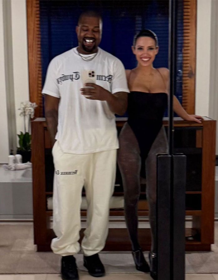 Bianca Censori in a daring outfit posing with a man, sparking debate over Grammy fashion choices. Bianca Censori in a daring outfit posing with a man, sparking debate over Grammy fashion choices.