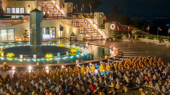 Colorful gathering of pilgrims at night at a Vietnamese temple, surrounded by illuminated scenery and architecture. Colorful gathering of pilgrims at night at a Vietnamese temple, surrounded by illuminated scenery and architecture.
