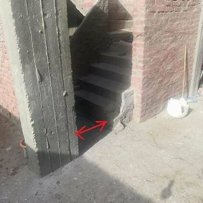 Concrete wall obstructing a staircase entrance, illustrating architecture fails.
