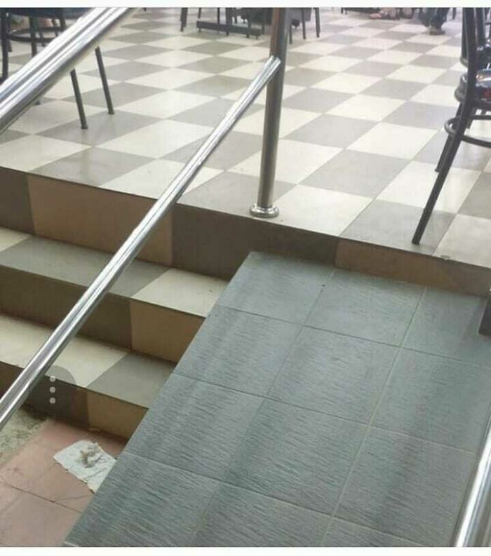 Uneven wheelchair ramp and stairs highlight an architecture fail with a confusing design.