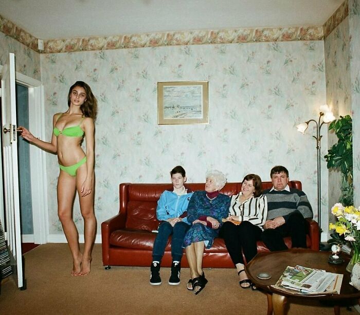 A tall woman in a green bikini stands next to a seated family in a living room, illustrating the strange internet world.