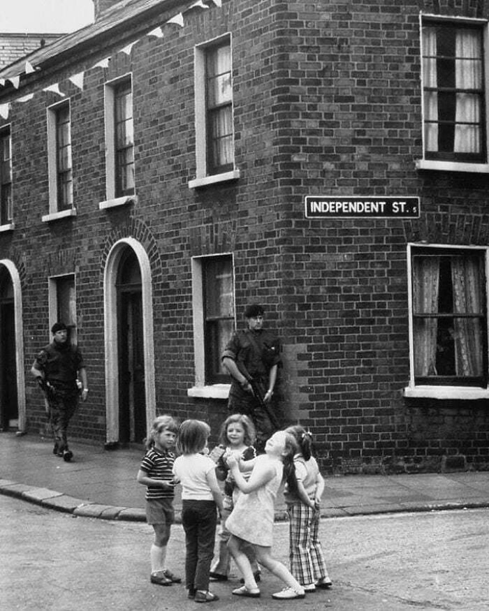 Children playing joyfully on Independent Street, capturing true happiness amidst a historic backdrop.
