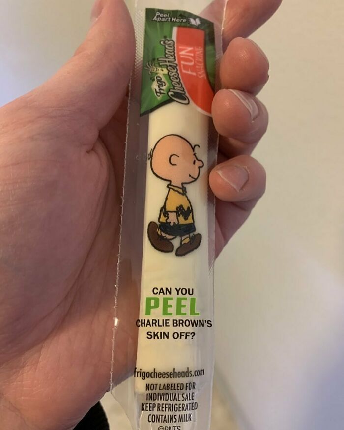 Design fail: Charlie Brown illustration on cheese packaging with humorous and dark text about peeling his skin.