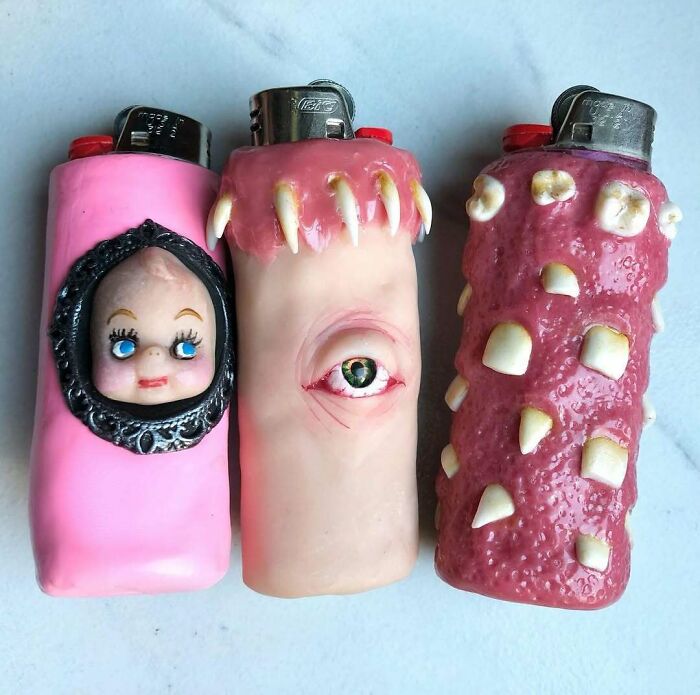 Creepy handmade crafts on lighters with faces, eye, and teeth designs.