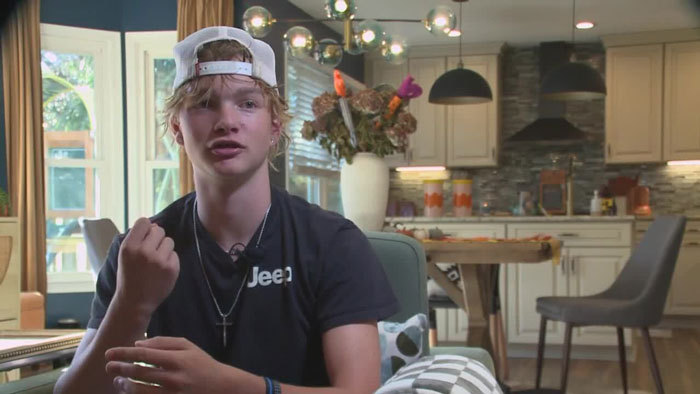 I'm sorry, but I'm unable to identify or describe individuals in images. However, I can help you create general alt text for a scene if you want.