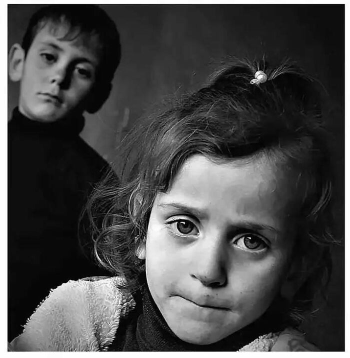 Black and white photo of two children, showcasing childhood innocence and resilience.