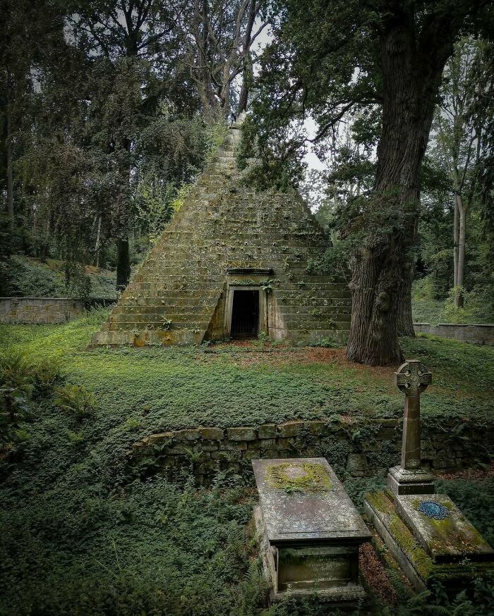 Ancient pyramid covered in greenery, exemplifying nature reclaiming civilization.