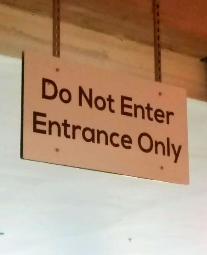 Confusing sign reads "Do Not Enter, Entrance Only," demonstrating a design fail.
