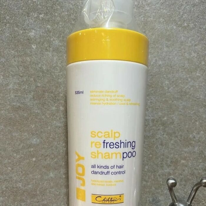 Shampoo bottle with misaligned text, showcasing design fails in packaging.