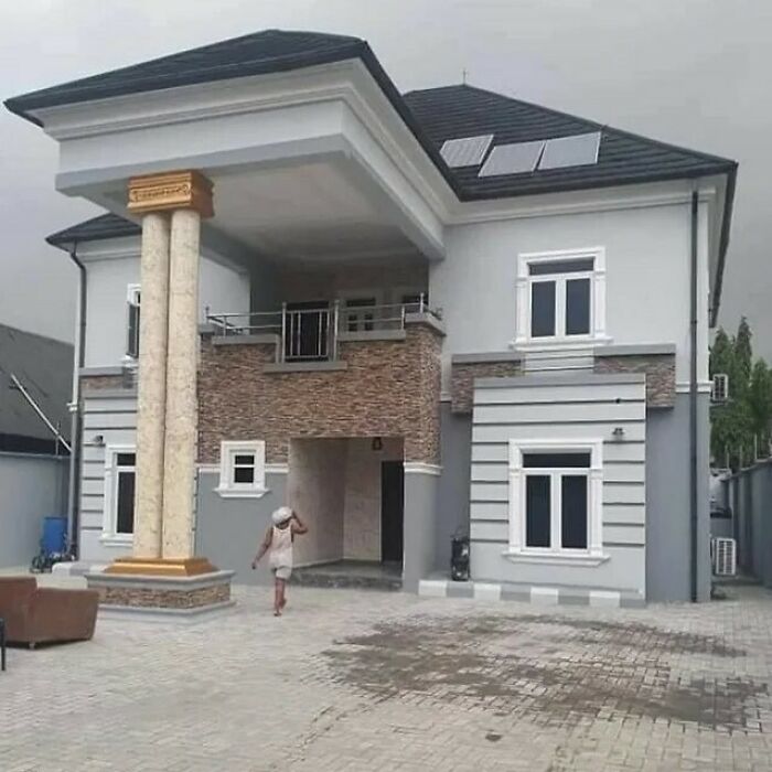 House with misaligned large column, showcasing design fails in architecture.