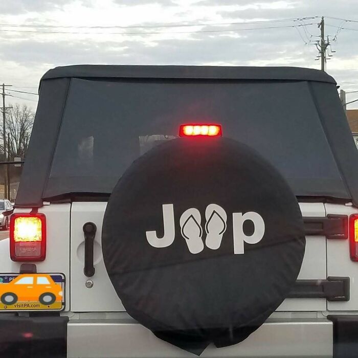 Jeep logo design fail with flip-flops replacing letters on spare tire cover.