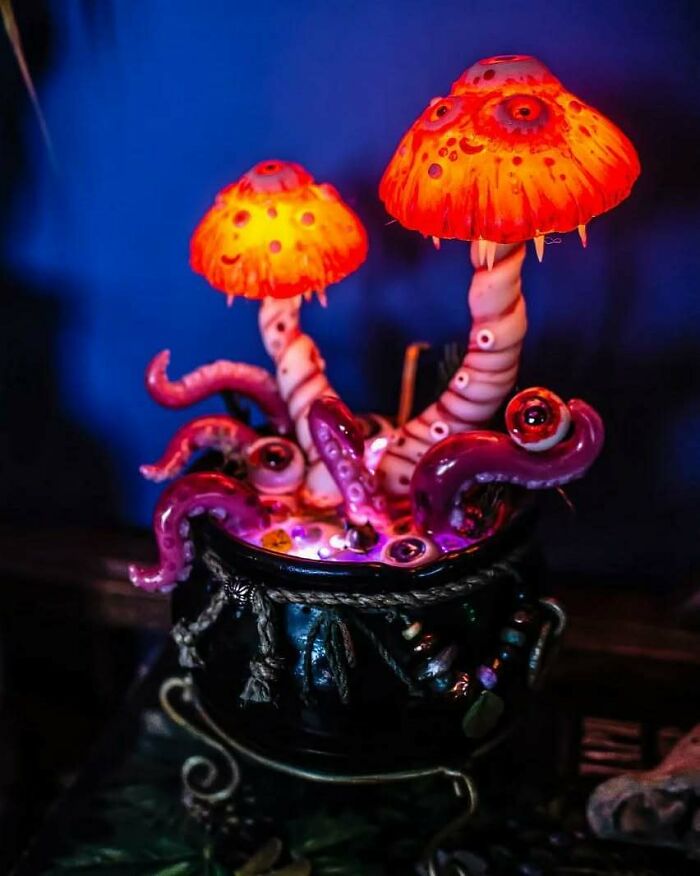 Creepy handmade craft featuring glowing orange mushrooms and tentacles in a black pot.