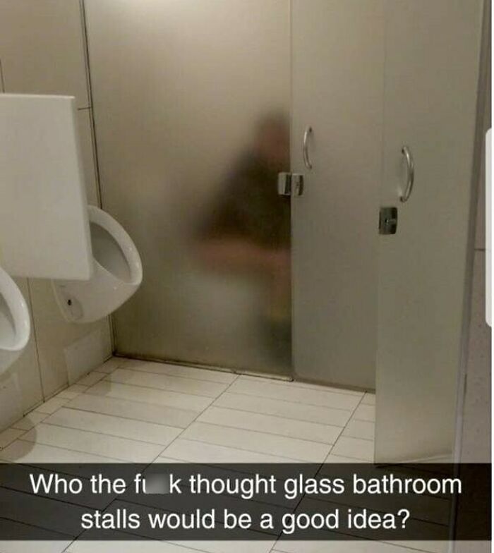 Frosted glass bathroom stall with visible silhouette highlighting a design fail.