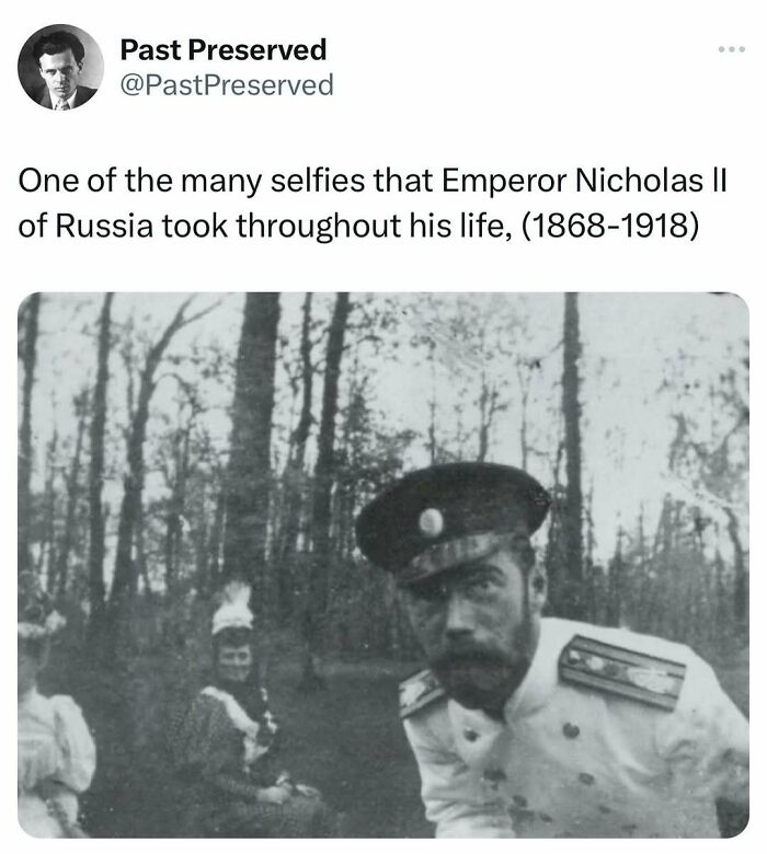 Emperor Nicholas II in a historical selfie, wearing a military uniform in a forested setting, capturing past preserved moments.