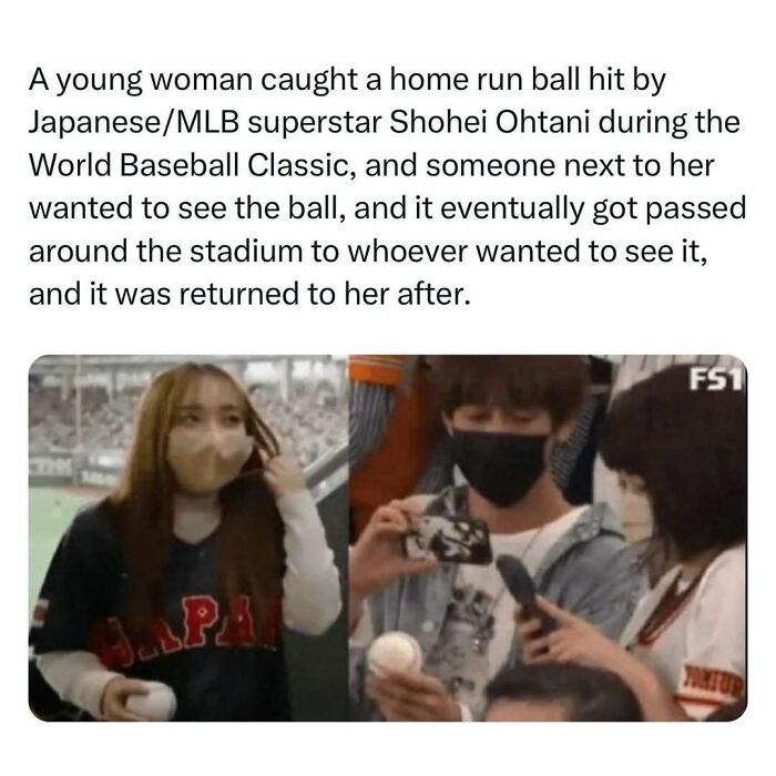 Young woman smiles after catching a home run ball at a baseball game while wearing a Japan jersey.