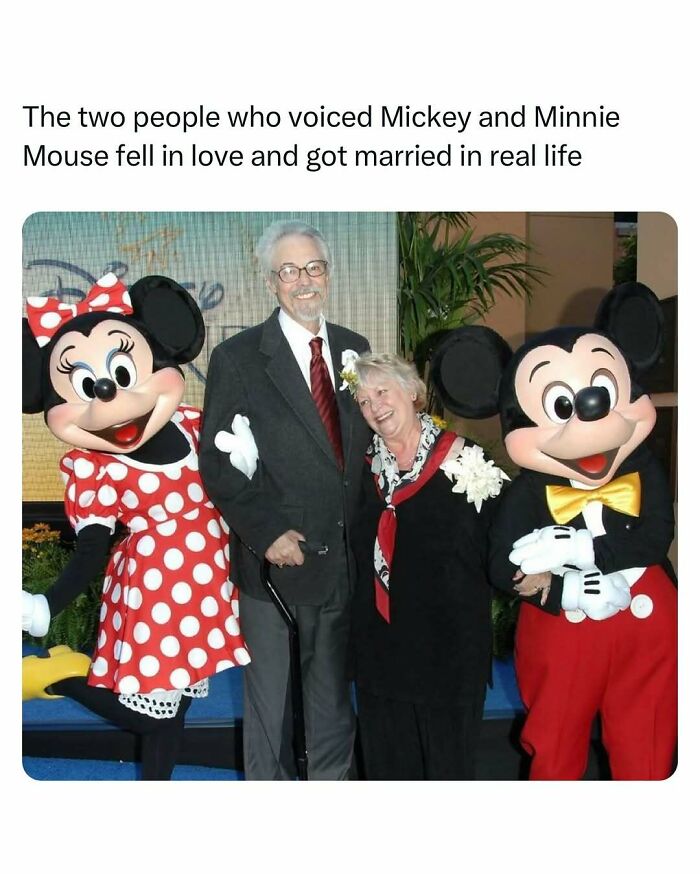 Couple who voiced Mickey and Minnie Mouse, smiling with characters, exemplify heartwarming joy.
