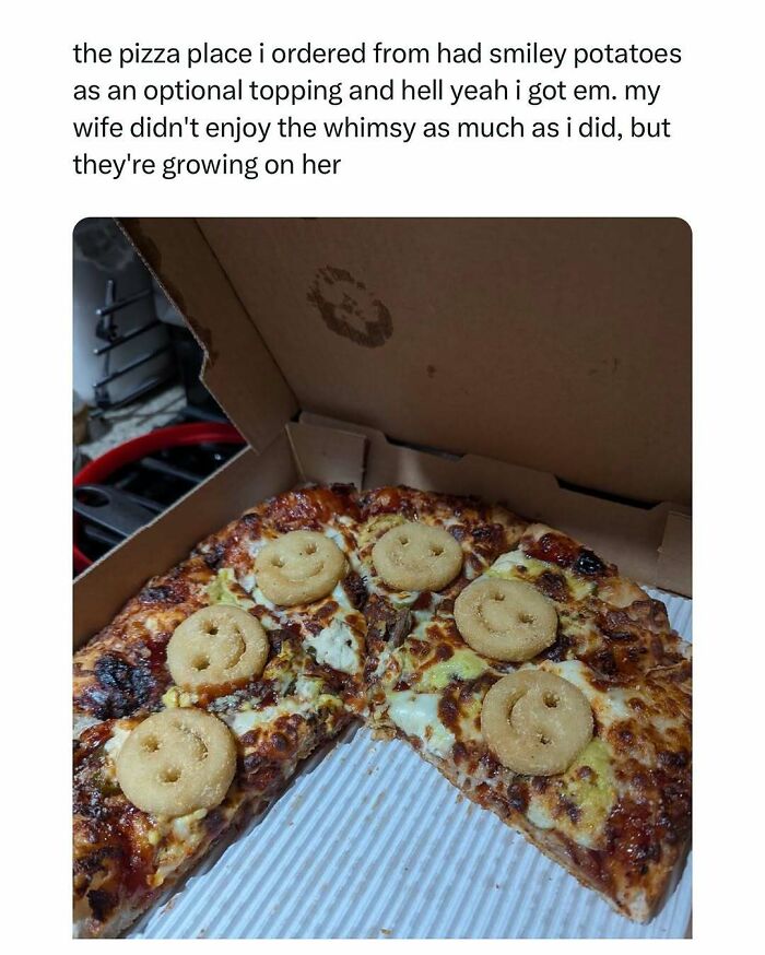 Pizza with smiley potato toppings in a box for a heartwarming meal experience.