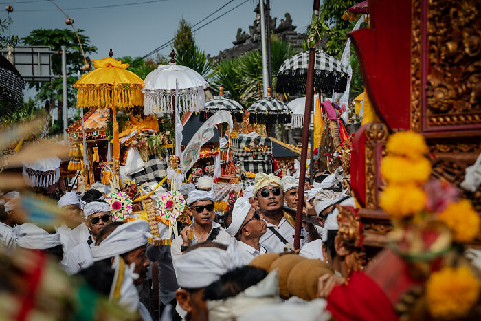 Bali's Galungan celebration with decorated umbrellas and traditional attire, showcasing a vibrant cultural procession.