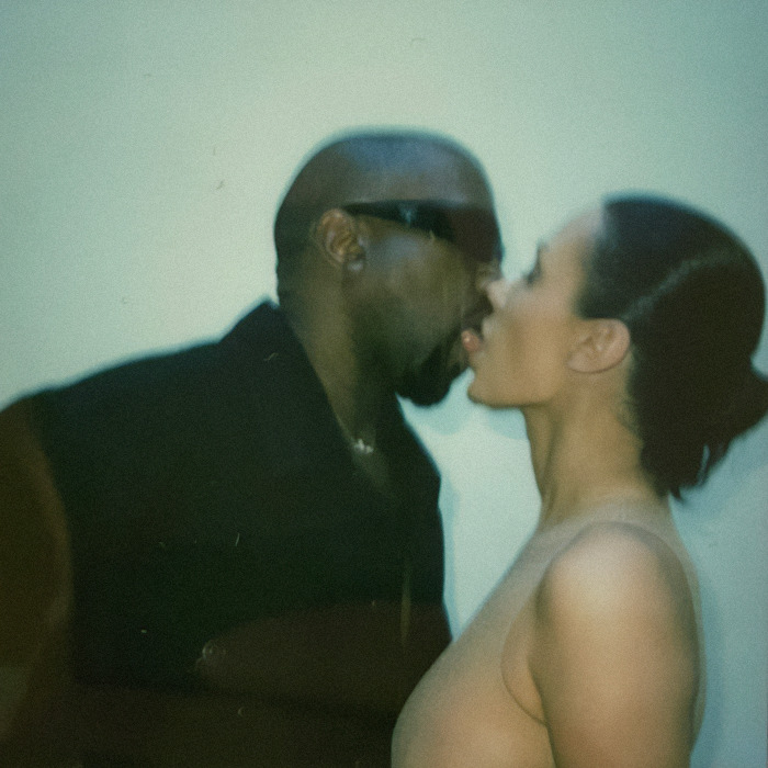 Kanye West and Bianca Censori kissing in front of a plain wall. Kanye West and Bianca Censori kissing in front of a plain wall.