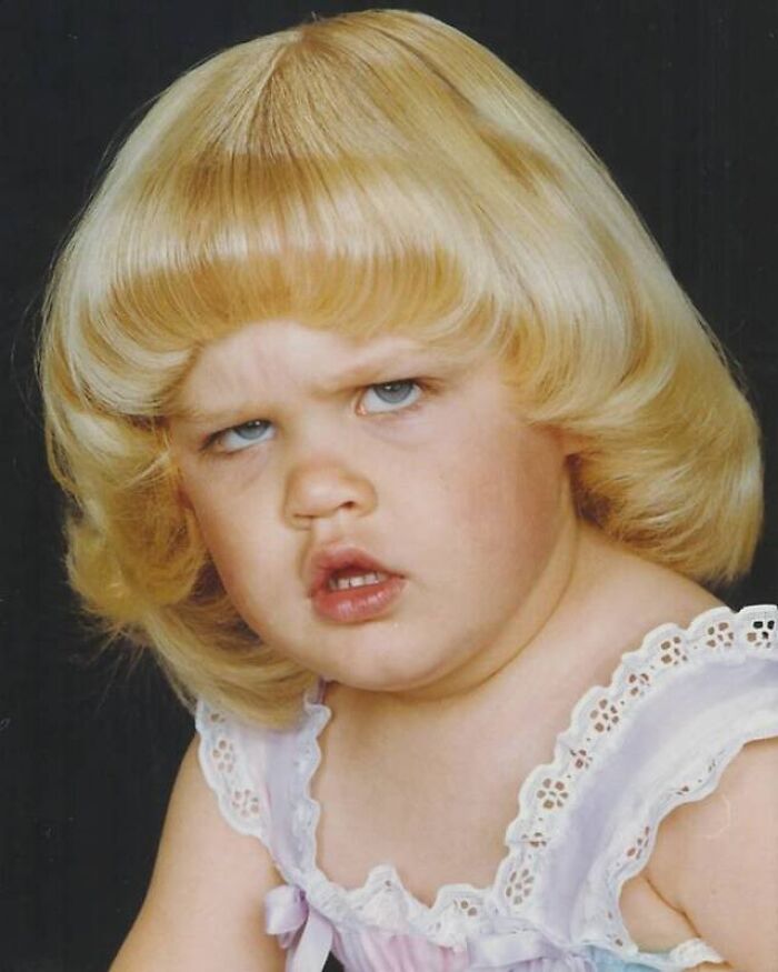 Toddler with voluminous blonde hair from the 1980s, showcasing an epic hair disaster expression.