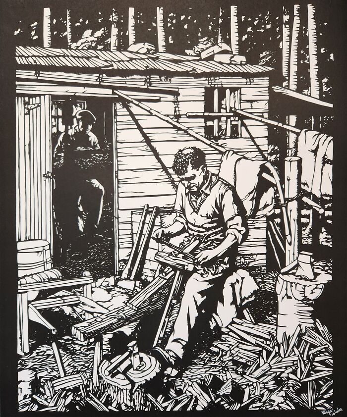 Hand-cut paper artwork depicting a man working with wood outside a rustic cabin.