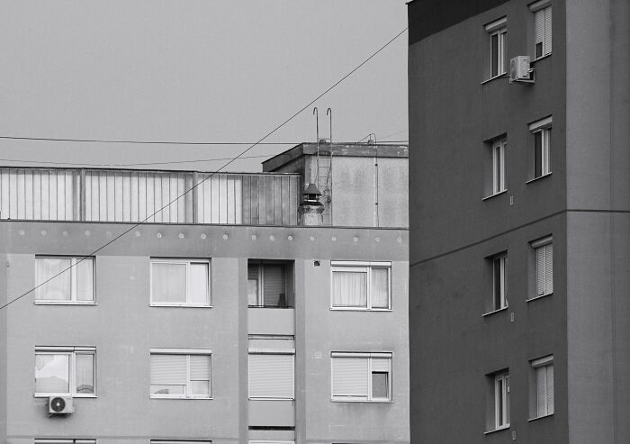 Hungary's panel buildings in black and white, showcasing architectural design and residential structure.