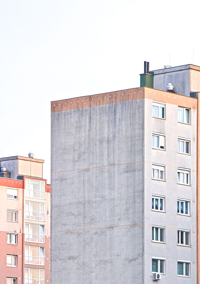 Hungary's panel buildings with colorful facades and minimalist design details captured from street level.