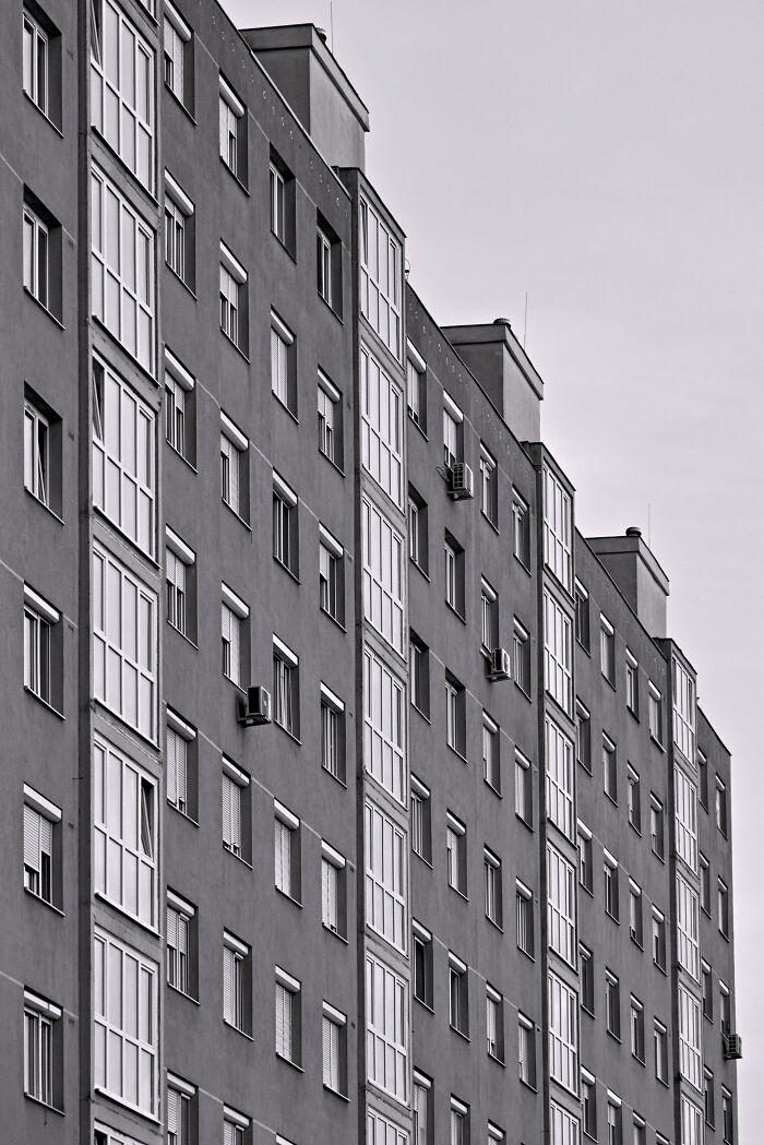 Hungary's panel buildings in black and white, showcasing geometric patterns and symmetrical windows.
