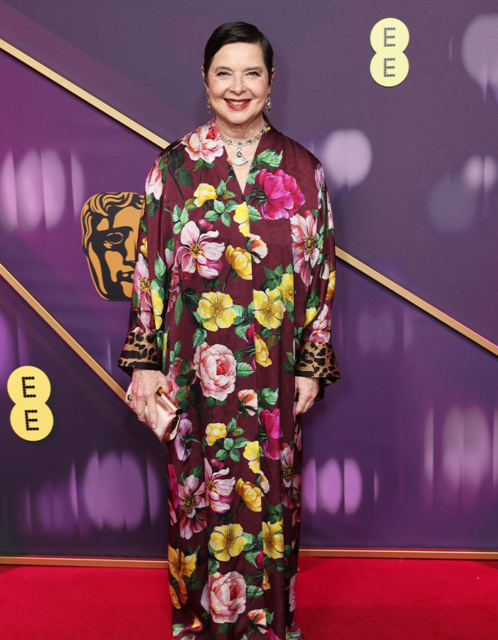 Person in floral outfit on the Bafta red carpet, showcasing daring fashion choices.
