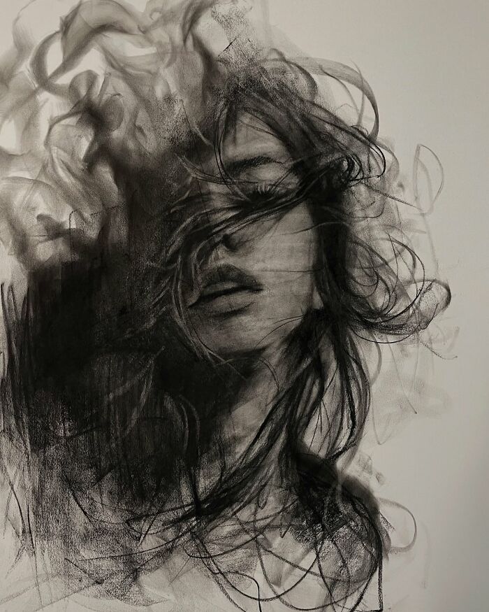 Charcoal portrait by artist Josh Hernandez featuring a woman with swirling hair, showcasing striking artistry.