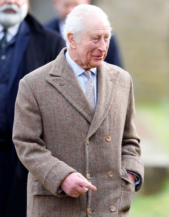Royal in tweed coat outside, raising concerns over potential royal crisis.