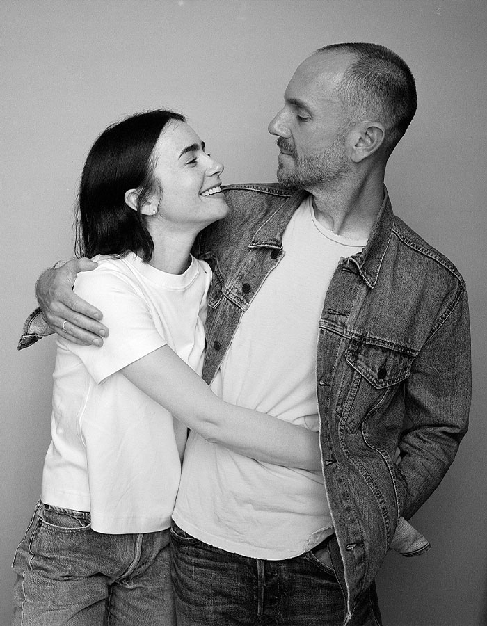 A couple embraces, smiling warmly at each other, wearing casual outfits. A couple embraces, smiling warmly at each other, wearing casual outfits.