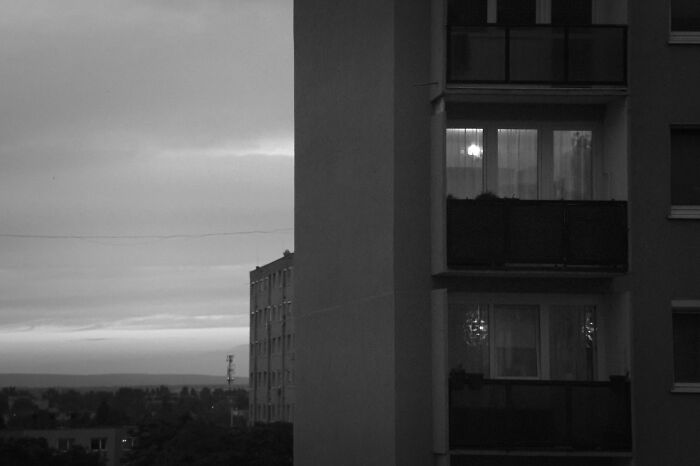 Hungary’s panel buildings in dim light, showcasing urban architecture against a cloudy sky backdrop.