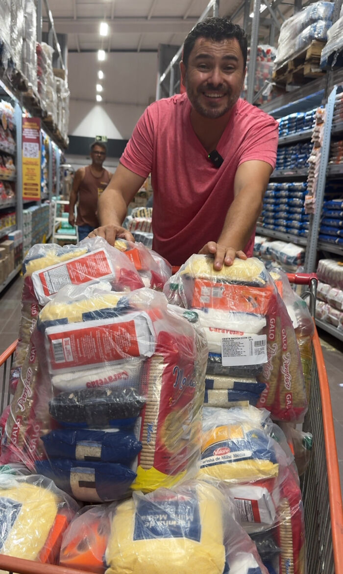 Man smiling, pushing a cart of food supplies, dedicated to feeding stray dogs for 25 years. Man smiling, pushing a cart of food supplies, dedicated to feeding stray dogs for 25 years.