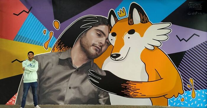 Chilean artist with his mural featuring a man and a whimsical fox, both with vibrant colors and geometric shapes.