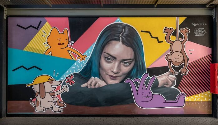 Chilean artist's mural featuring a woman surrounded by colorful cartoon animals, showcasing vibrant creativity.