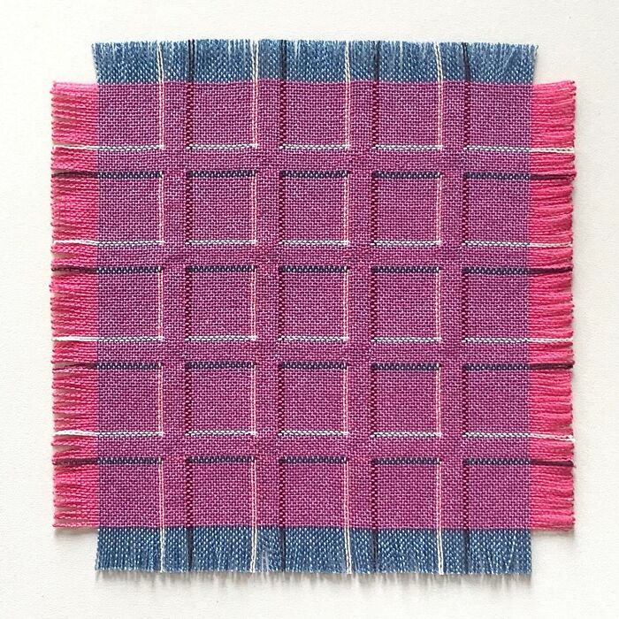 Intricate geometric weave art with pink square patterns creating optical illusions on a light background.
