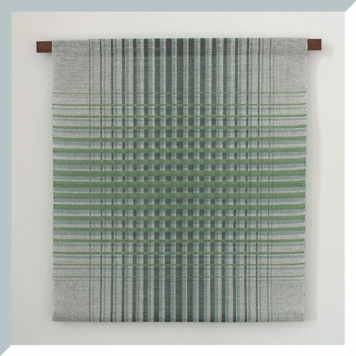 Intricate geometric weave art with green and gray patterns creating optical illusions.