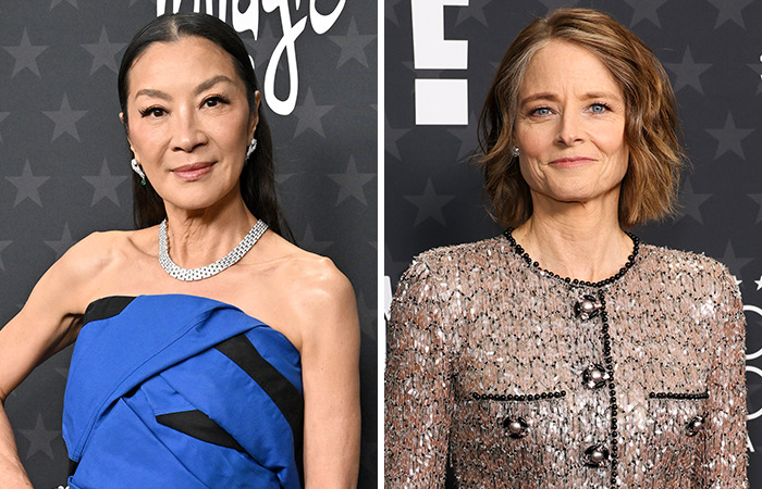 Michelle Yeoh and Jodie Foster, both wearing elegant dresses, posing on the red carpet.