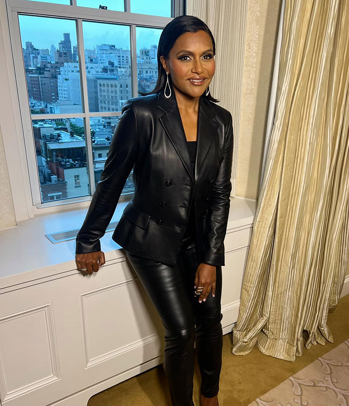 Mindy Kaling in a black leather outfit, showcasing a slim figure at a movie premiere.