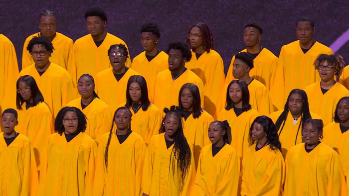 Choir in yellow robes performing national anthem at Super Bowl LIX. Choir in yellow robes performing national anthem at Super Bowl LIX.