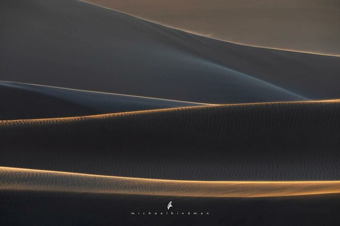 Gentle sand dunes under soft light, showcasing nature's textures in an intimate landscape photo by Michael Hindman.