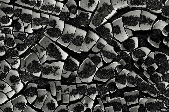 Textures of nature in an abstract pattern of c*****d, dark surfaces.