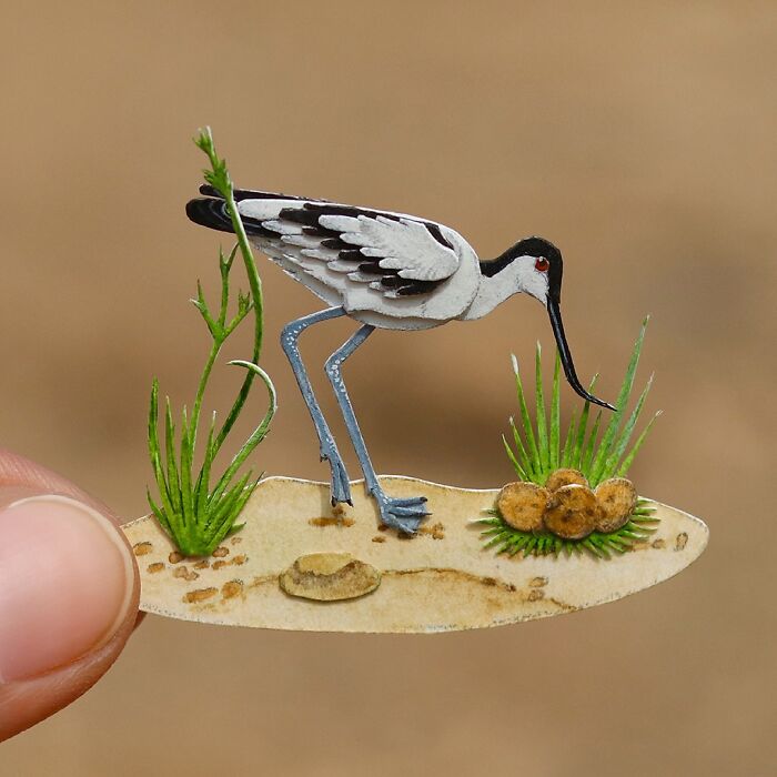 Miniature realistic paper art of a bird, showcasing intricate details to spark conservation conversations.