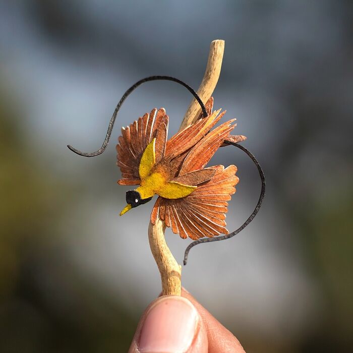 Miniature realistic paper art of a bird, created to spark conversation about animal conservation.