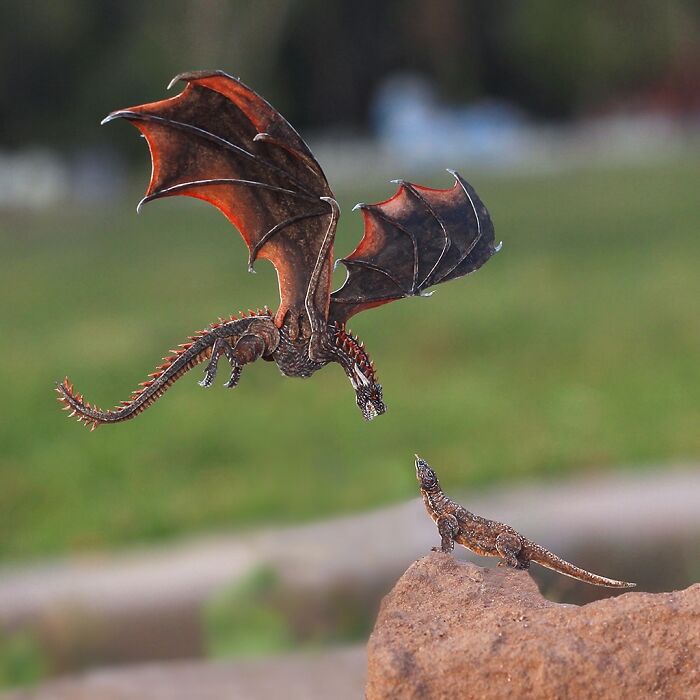 Miniature realistic paper art dragon and lizard on a rock, highlighting conservation themes.