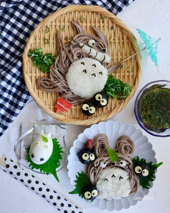 Creative lunchbox featuring a Japanese artist's Totoro-themed bento with rice and noodles arrangement.