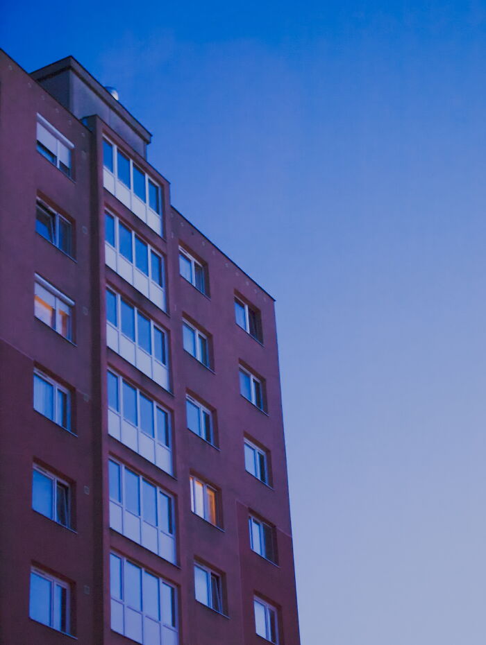 Hungary panel building against a blue sky at dusk.