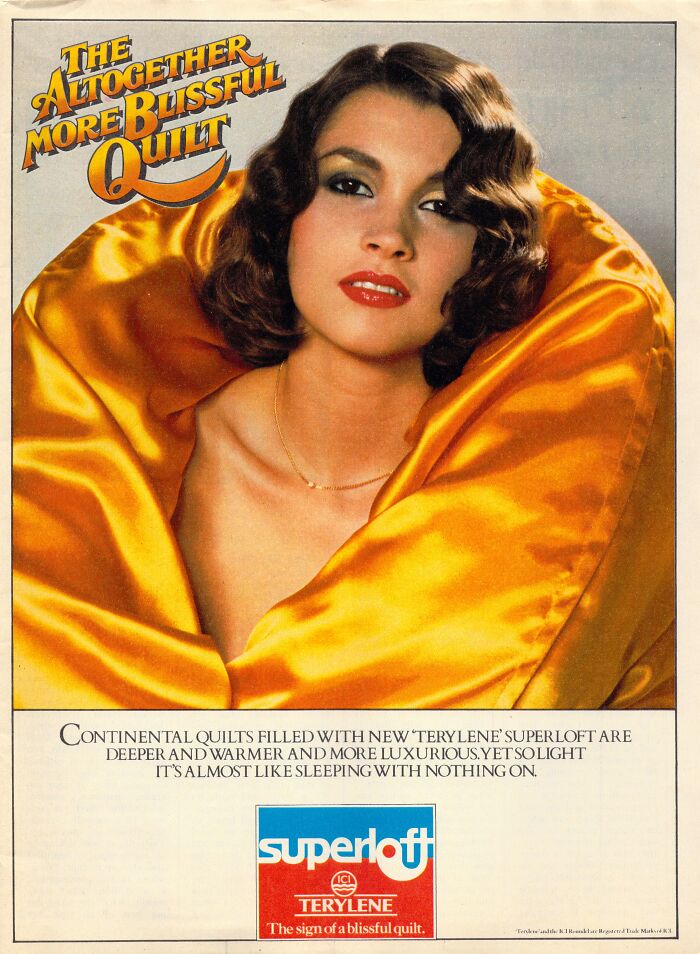 Woman wrapped in a golden quilt with "The Altogether More Blissful Quilt" text, representing vintage-commercials style.