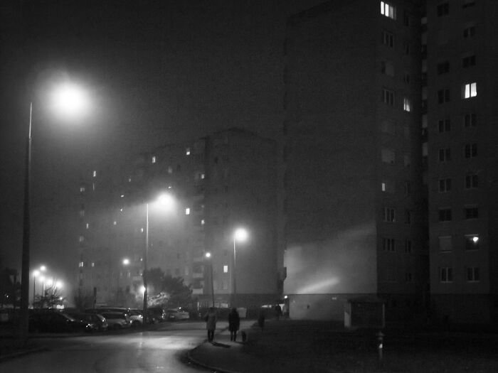 Night view of Hungary’s panel buildings with streetlights illuminating the scene.